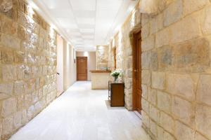 a hallway of a building with a stone wall at Rami Hotel in Fālūghā