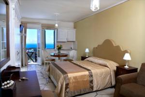 A bed or beds in a room at Dafnoudi Hotel Apartments