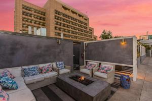 a rooftop patio with a couch and a fire pit at One Lux Stay HWH Downtown Los Angeles in Los Angeles