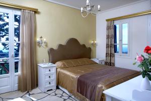 A bed or beds in a room at Dafnoudi Hotel Apartments