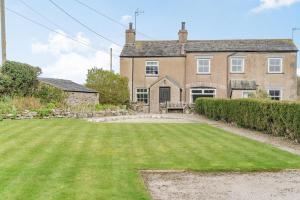 an exterior view of a house with a large yard at Pye Hall Cottage in Silverdale