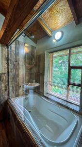 a bathroom with a large tub and a sink at Unuwasi Hotel & Villa in Calca