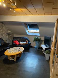 a living room with a couch and a coffee table at Ferienwohnung Bussard in Patersberg