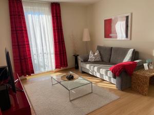 a living room with a couch and a table at Lakeview Appartements in Zeuthen
