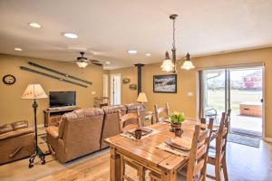 a dining room and living room with a table and chairs at Bozeman Condo with Grill about 2 Mi to Hot Springs! in Bozeman