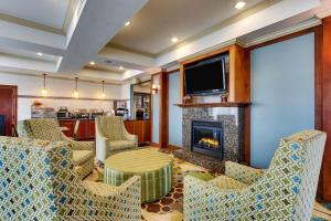 a living room with chairs and a fireplace at Best Western Plus Woodway Waco South Inn & Suites in Waco