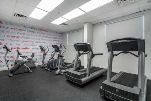 a gym with cardio equipment in a room at Best Western Plus Vancouver Airport Hotel in Vancouver