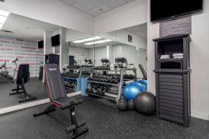 a gym with several exercise equipment in a room at Best Western Plus Vancouver Airport Hotel in Vancouver