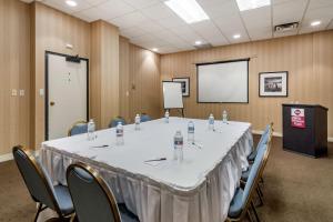 a conference room with a table and chairs and a screen at Best Western Plus Vancouver Airport Hotel in Vancouver