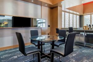 a conference room with a glass table and chairs at Best Western Plus Vancouver Airport Hotel in Vancouver +59 photos