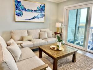 a living room with a couch and a coffee table at Driftwood Cottage - First floor OCEANFRONT beach retreat! Exceptional views, location and privacy condo in Carolina Beach