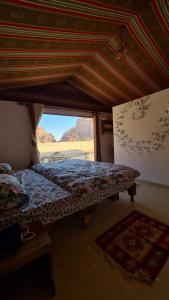 a bedroom with a bed in a room with a window at wadi rum Martian camp in Wadi Rum
