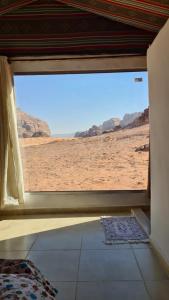 a window in a room with a view of the desert at wadi rum Martian camp in Wadi Rum