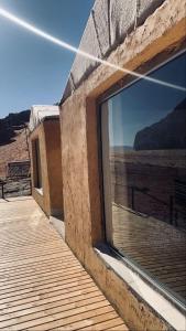 a window of a building with a view of the desert at wadi rum Martian camp in Wadi Rum