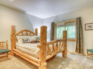 a bedroom with a wooden bed and a window at Barlow Trail Lodge - Meredith Lodging in Rhododendron +52 photos