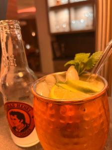 a drink in a bowl next to a bottle at Safranberg Hotel & Sauna in Ulm