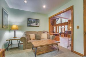 a living room with a couch and a table at River Dance Retreat - Meredith Lodging in Welches