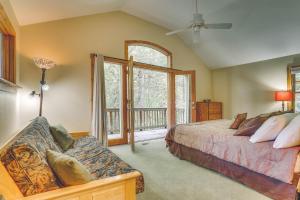 a bedroom with a bed and a large window at River Dance Retreat - Meredith Lodging in Welches
