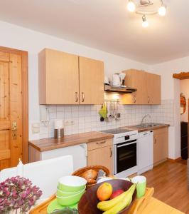 eine Küche mit einem Tisch und einer Obstschale darauf in der Unterkunft Haus Koch-Lechner in Marquartstein