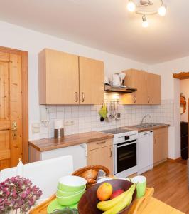 a kitchen with a table with a bowl of fruit on it at Haus Koch-Lechner in Marquartstein