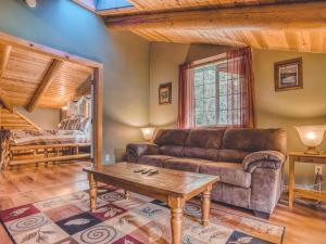 a living room with a couch and a coffee table at Forest View Lodge - Meredith Lodging in Welches