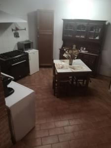 
a kitchen with a sink, stove, and refrigerator at Antico Borgo di Torri in Sovicille
