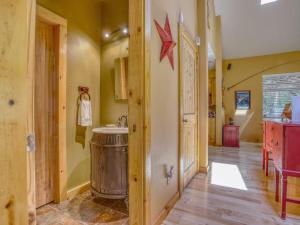 a hallway of a house with a sink and a kitchen at Salmon River Chalet - Meredith Lodging in Welches +132 photos