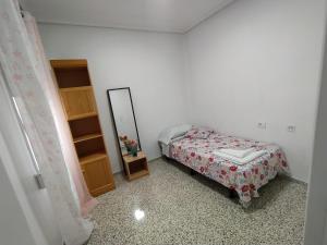 a small bedroom with a bed and a mirror at Piley apartamento en vila-real in Villareal