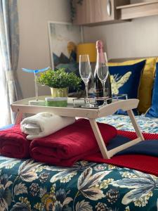 a table with wine glasses on top of a bed at Deluxe 3 bedroom caravan in Haven's Seton Sands Holiday Village,Wifi in Port Seton