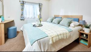 a bedroom with a large bed with a vase on it at AJL Rentals in Turnberry
