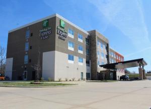 a large building with a parking lot in front of it at Holiday Inn Express & Suites Warrensburg North, an IHG Hotel in Warrensburg