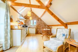 a kitchen with a table and a chair in a room at The Bothy in Ross on Wye