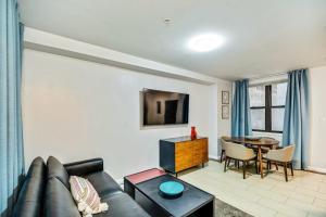 a living room with a couch and a table at Bee Home in the City in Philadelphia