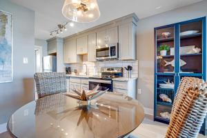 a kitchen with a glass table and some chairs at Boho Bayshore 42 in Ocean City