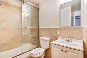 a bathroom with a shower and a toilet and a sink at New and Cozy 1BD Apt in the heart of Philly! in Philadelphia