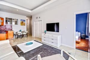a living room with a couch and a tv at Escape to Philly and stay in our place! 2BD Apartment in Philadelphia