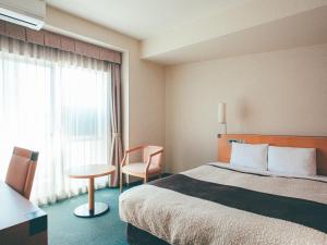 Postel nebo postele na pokoji v ubytování Kuretake Inn Okayama