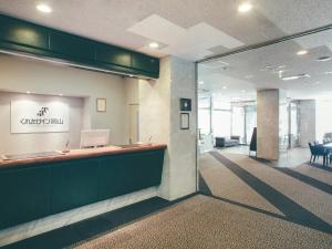 an office lobby with a reception desk with a laptop at Kuretake Inn Okayama in Okayama