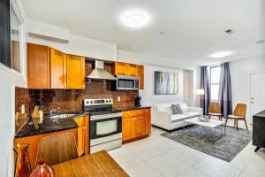 a kitchen with wooden cabinets and a living room at The Vacationers place in Philadelphia