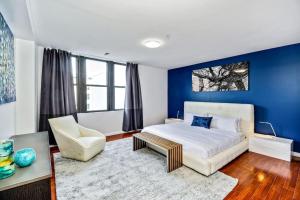 a bedroom with a bed and a blue wall at Be My Guest Gorgeous 2BD next to Reading Terminal in Philadelphia