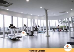 a fitness center with people exercising in a gym at Rasa Sayang Homestay @ I-Soho, I-City in Shah Alam