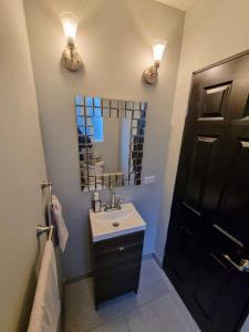 a bathroom with a sink and a mirror at Clean&Equipped, 1-Floor 3-Bedroom Downtown House in Ensenada