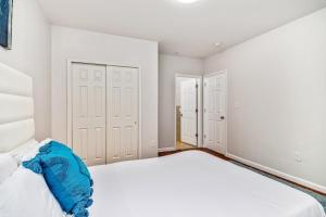 a white bedroom with two closets and a bed at Lovely 2bd Apt steps from the Convention Center in Philadelphia