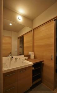 a bathroom with a sink and a mirror at M House in Furano