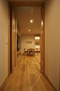 a hallway with a dining room and a table at M House in Furano
