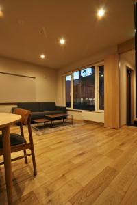 a living room with a couch and a table at M House in Furano