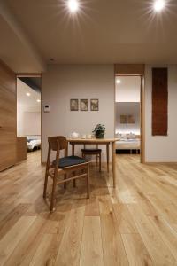 a dining room with a table and chairs and a bedroom at M House in Furano