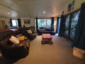 a living room with couches and a coffee table at Garden Studio in Jaggan