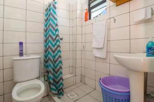 a bathroom with a toilet and a sink at Lux Suites Rio Vista Executive Studio Apartments in Makandara