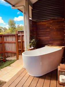 a white bath tub sitting on a deck at Grape Juice Retreat in Margaret River Town